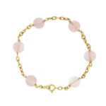 Bracciale maglia forzatina in oro giallo 18 kt con 6 sfere di quarzo rosa da 1 cm, chiusura con moschettone.