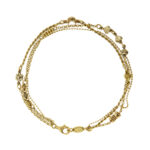 Bracciale multi fili in oro giallo 18kt composto da: una maglia a palline, uno maglia corda con fiore in oro bianco, luna in oro rosa e cuore in oro giallo e uno maglia rolò con inserti di maglia marina 3 ori, 5 anellini, 3 cuori e un fiocco.