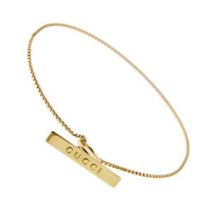 Bracciale maglia veneta in oro giallo 18kt con targhetta loggata pendente e chiusura a T. Brand: Gucci.