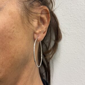 Foto gioiello indossata: orecchini a cerchio in oro bianco