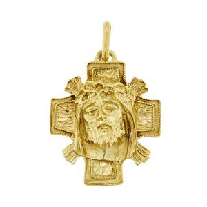 Ciondolo a croce in oro giallo 18kt con lavorazione oro grezzo con volto di Gesù in rilievo.